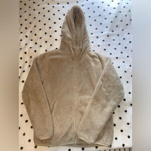 Tan TNA fluffy zip up sweater in a size small.